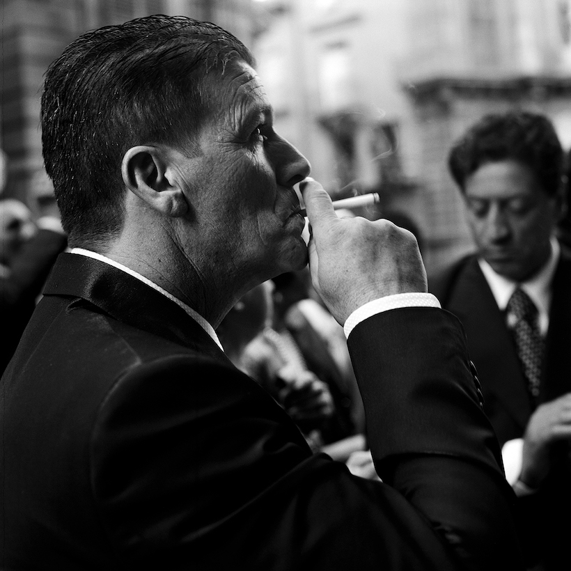 A wedding invitee enjoys a cigarette outside the church. June 2012